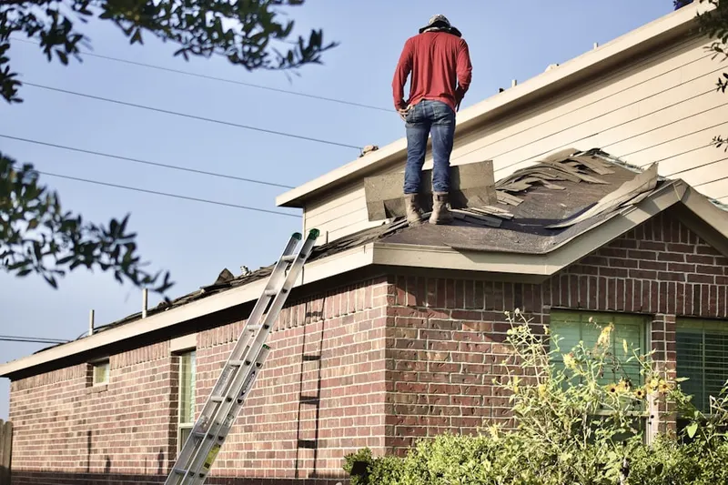 Professional roofer working on a residential roof in Pin Oak Village